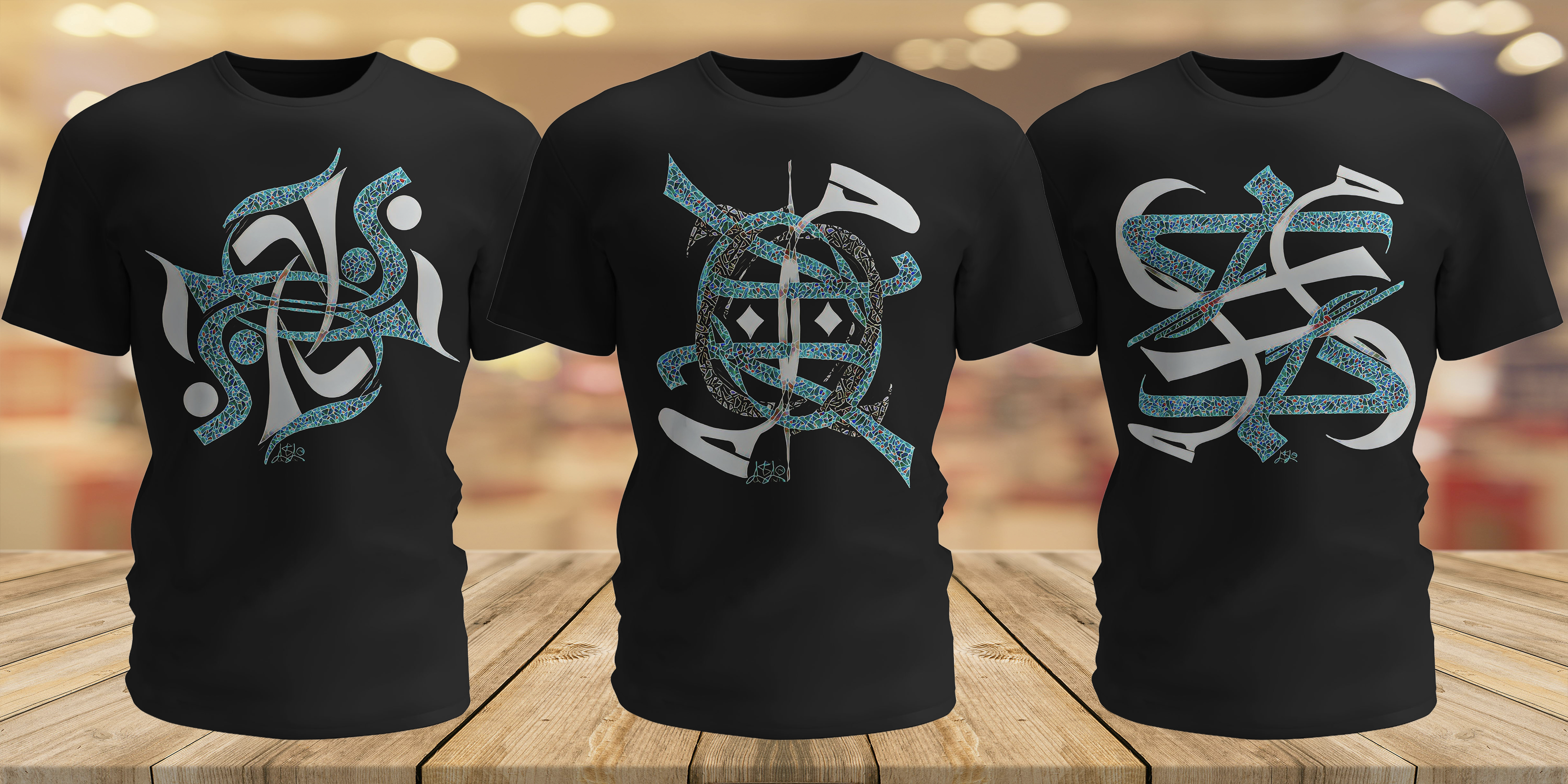 Three black t-shirts with blue and white designs on a wooden surface.