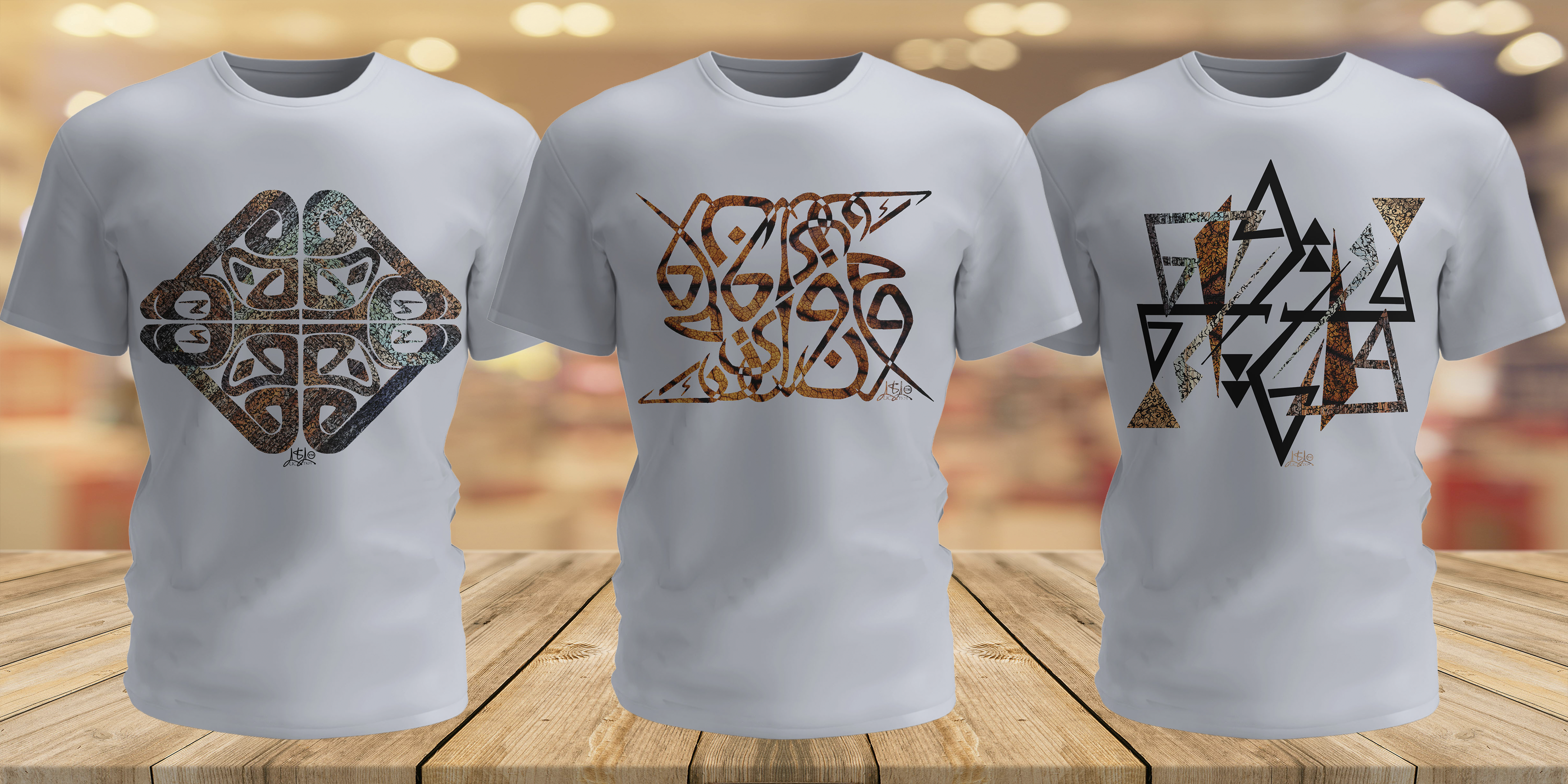 Three white t-shirts with wood/leaf background on a wooden surface.
